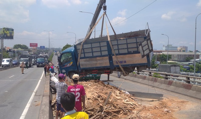 Xe tải rớt bánh lật trên quốc lộ 1A ở Sài Gòn, nhiều người thoát chết, giao thông ùn ứ kéo dài   - Ảnh 2.