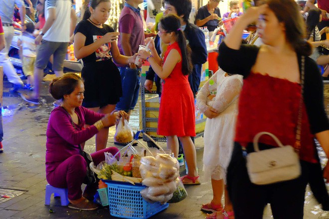  Đẩy xe lăn, người đàn ông này vẫn chen vào dòng người trên phố, bán từng tấm vé số mưu sinh đêm Giao thừa  - Ảnh 6.