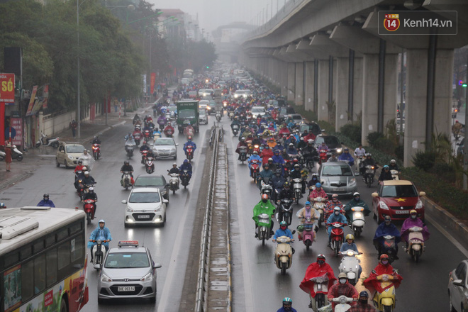 Chùm ảnh: Hà Nội mưa phùn, các tuyến đường thông thoáng trong ngày đi làm đầu tiên của năm mới Mậu Tuất - Ảnh 1.