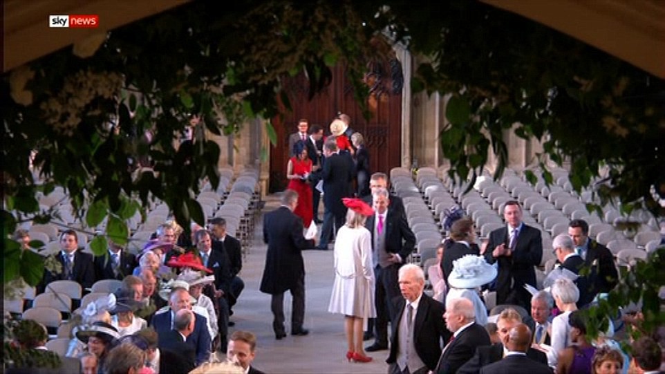 Guests are gathering inside the famous chapel where Meghan will enter alone in just a few hours