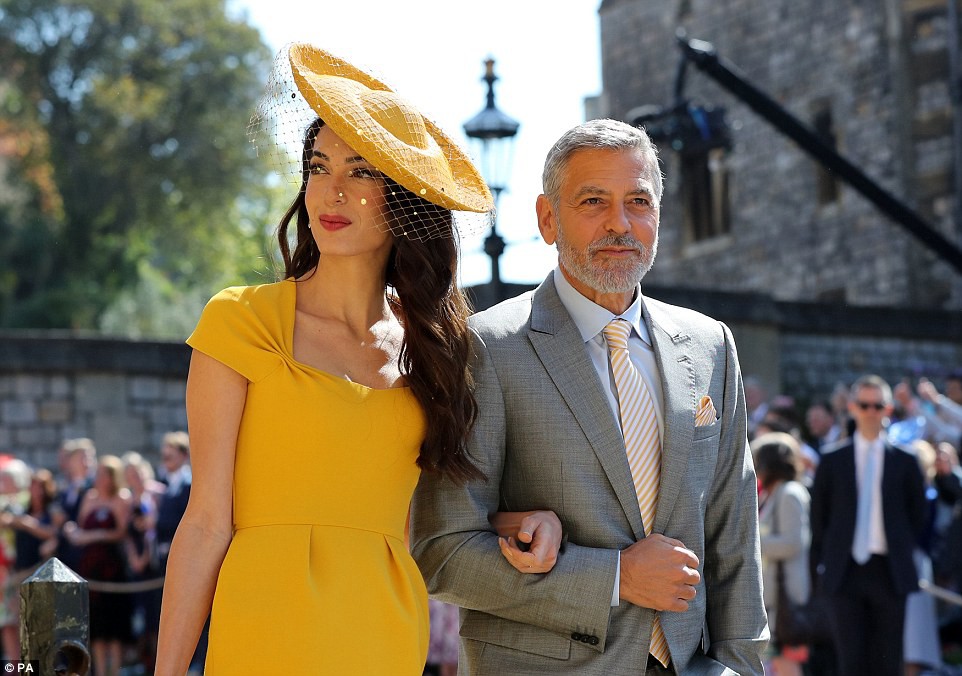 Tinseltown's finest: Hollywood legend George Clooney paid tribute to his wife's yellow gown with an accented tie and handkerchiefÂ Â 