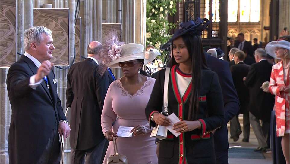 Oprah Winfrey (left in pink) joins Luther star Idris Elba and his fianceeÂ Sabrina Dhowre as they make their way into the chapel to watch Prince Harry and Megan Markle tie the knot