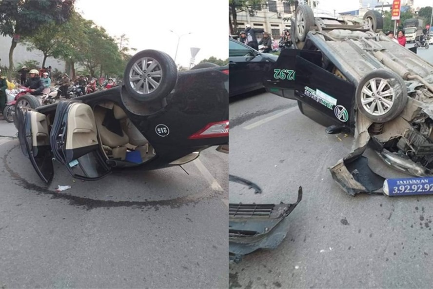 Người dân cạy cửa xe taxi lật ngửa cứu 2 người bị thương - Ảnh 1. Người dân cạy cửa xe taxi lật ngửa cứu 2 người bị thương - Ảnh 1.