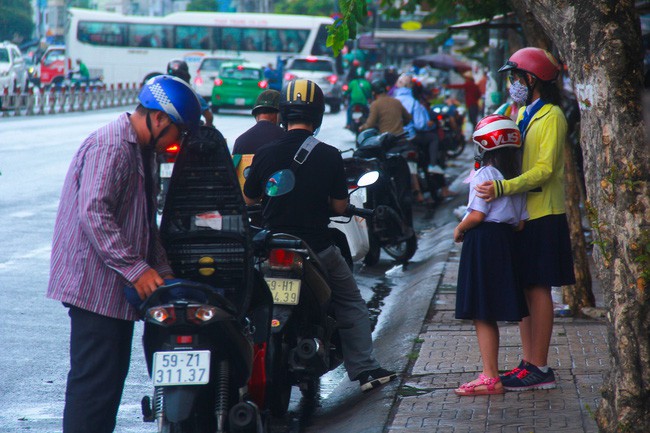 Người Sài Gòn trở tay không kịp, người ướt sũng chạy cơn mưa sau nhiều tháng nắng gắt - Ảnh 2.