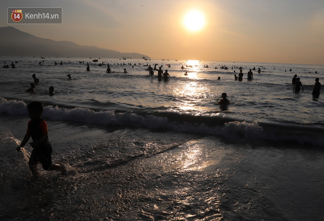 Hàng nghìn du khách và người dân ở Đà Nẵng đổ xô đi tắm biển giải nhiệt lúc sáng sớm - Ảnh 1.