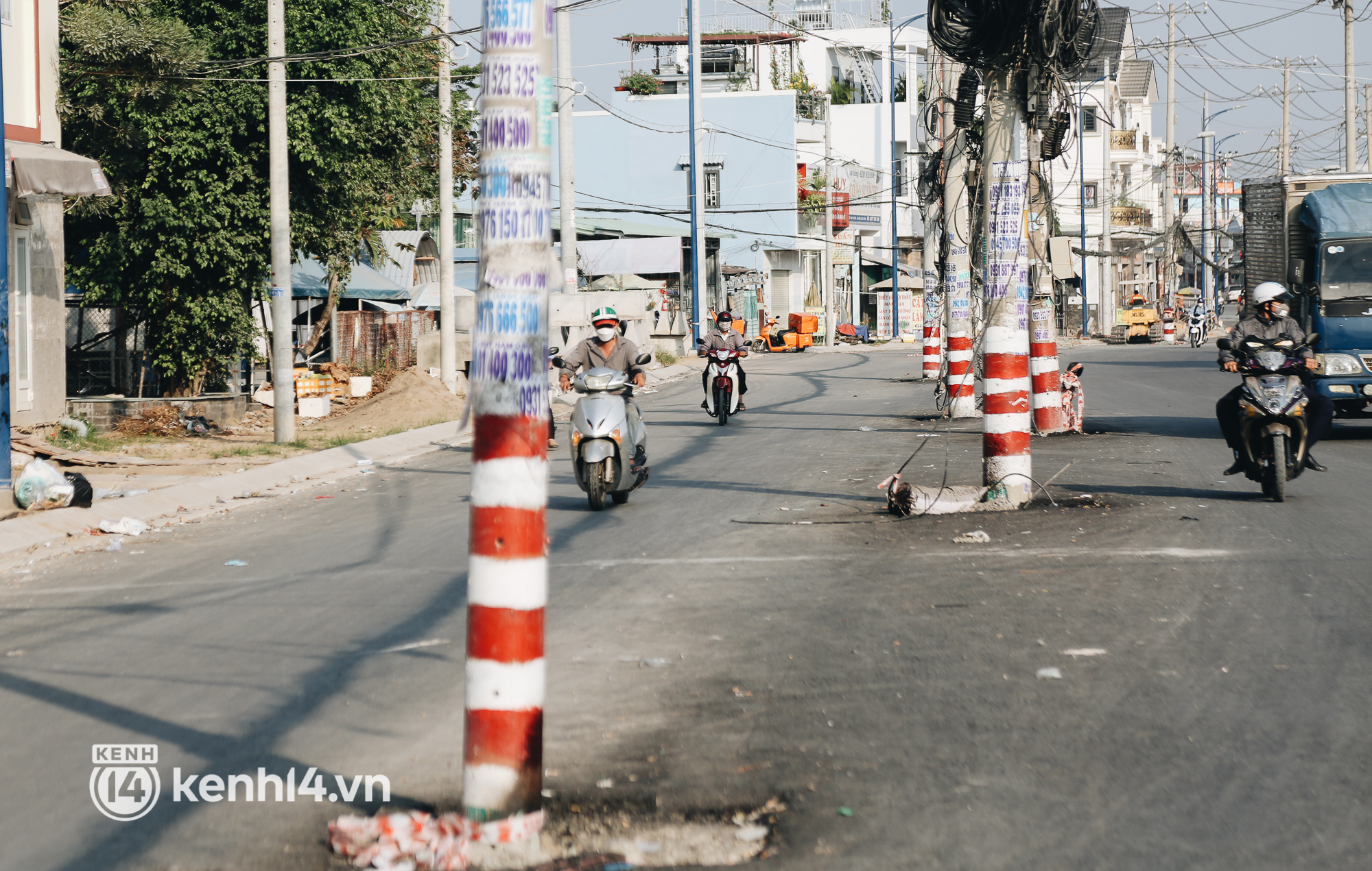 Hàng trăm cột điện bị bỏ quên giữa đường ở Sài Gòn, người dân nín thở luồn lách - Ảnh 8.