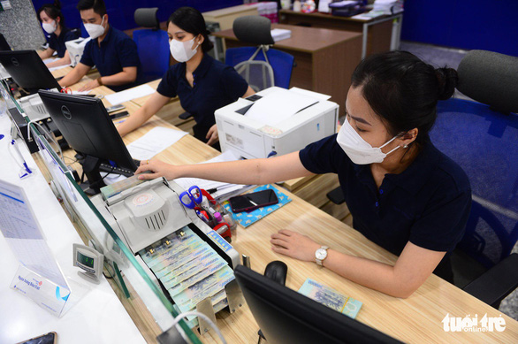 Tiền gửi của người dân tại ngân hàng được Nhà nước đảm bảo trong mọi trường hợp - Ảnh 1.