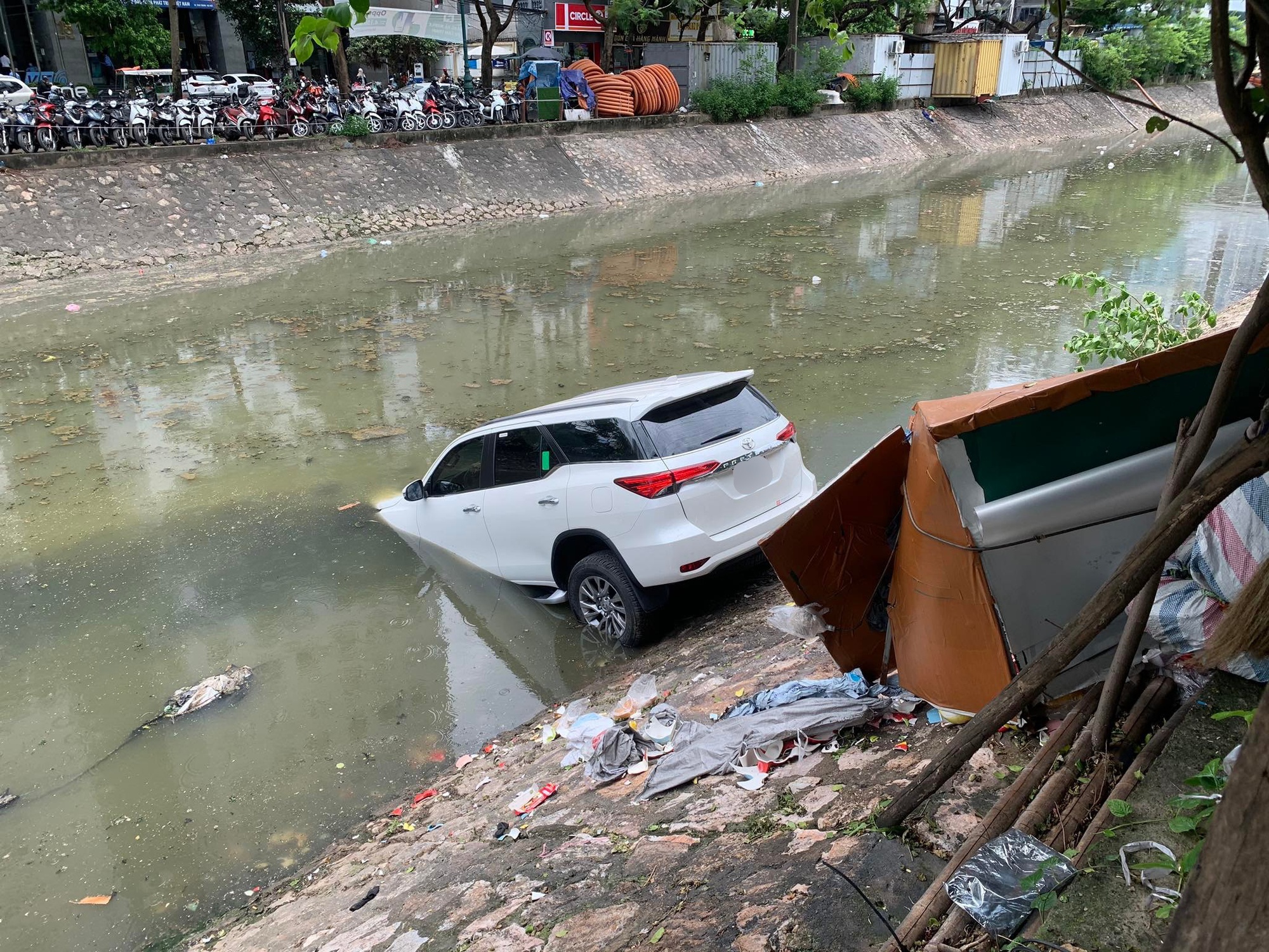 Hà Nội: Xe ô tô lao xuống sông Kim Ngưu giữa trưa, đội cứu hộ và người dân <a href='https://www.giaicuu.com' target='_blank'>giải cứu</a> sau một tiếng - Ảnh 1.