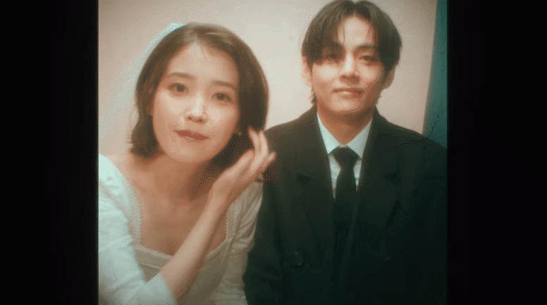 IU nắm chặt tay V kh&ocirc;ng rời, c&ograve;n l&agrave;m hẳn đ&aacute;m cưới ngọt ng&agrave;o với nam thần BTS trong MV mới! - Ảnh 4.