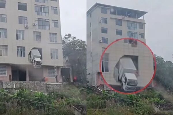 Xe tải đâm xuyên tường tầng 2 tòa nhà, hình ảnh đầu xe mắc kẹt giữa không trung gây sốc- Ảnh 1.