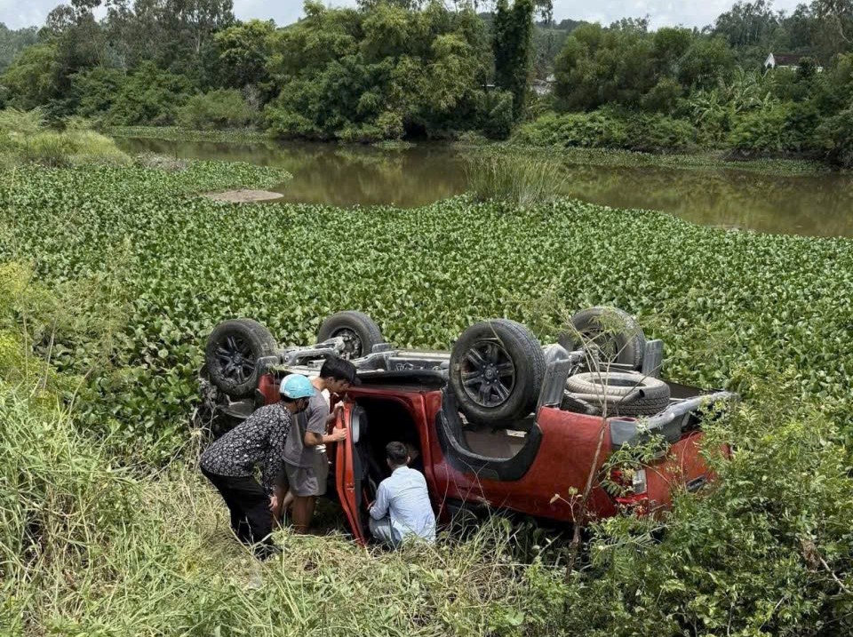 Xe bán tải do người phụ nữ mang thai điều khiển tông hàng loạt cọc tiêu rồi lao xuống sông- Ảnh 1.