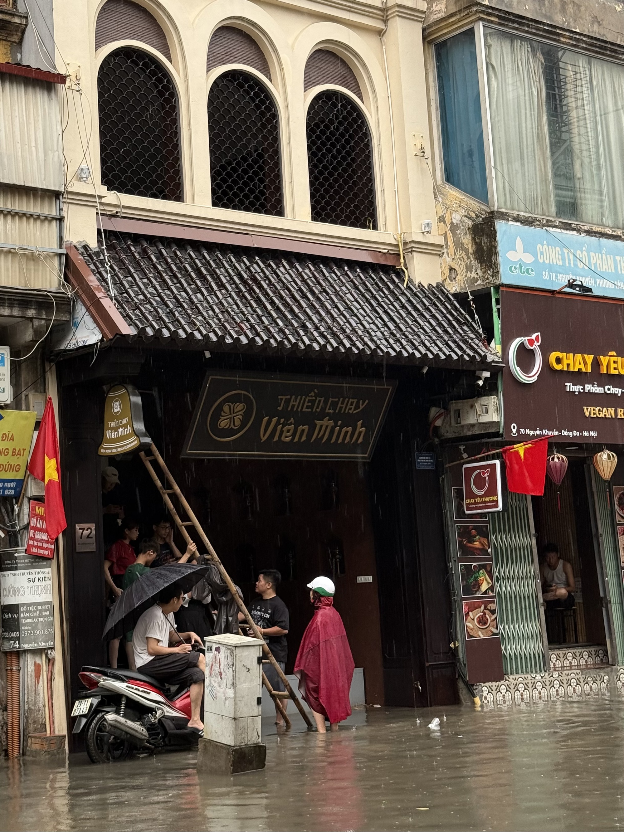 Loạt hàng quán ngập nước vẫn mở cửa, trở thành chỗ trú cho khách giữa thời tiết mưa lớn ở Hà Nội- Ảnh 11.