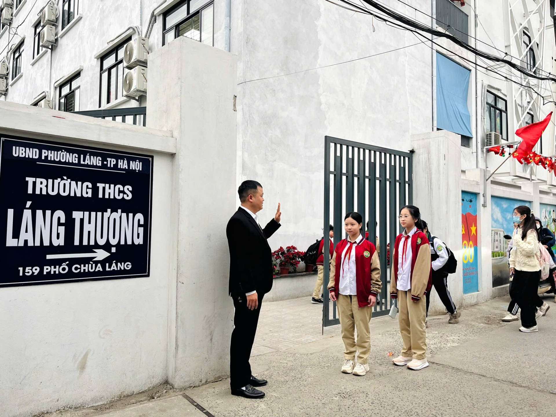 Bức ảnh thầy gi&aacute;o trước cổng trường ở H&agrave; Nội nhận "b&atilde;o" like, phụ huynh rần rần khen: "Thật ấn tượng"- Ảnh 1.