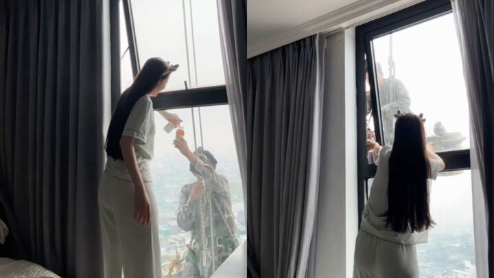 M&aacute;t l&ograve;ng cảnh c&ocirc; g&aacute;i mời nước anh thợ treo m&igrave;nh giữa trời n&oacute;ng lau k&iacute;nh cao ốc- Ảnh 1.