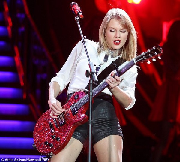 Taylor Swift shows off her long, shapely legs and plays the guitar 9