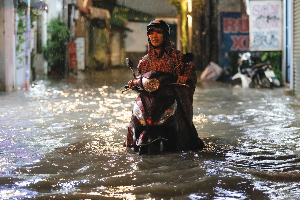 The people of Saigon struggled with the road flooded with wheels, the water flowed like a waterfall on a rainy night - Photo 16.