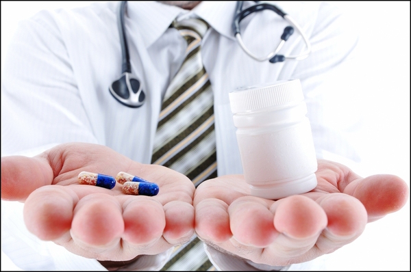 stockfresh_1391980_young-doctor-offering-pill-in-one-and-pills-in-bottle-in-another-hand-copy-space-for-you-for-tex_sizeS-d93e2.jpg