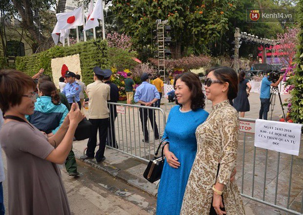 Chưa đến ngày khai mạc, nhiều người dân Hà Nội vẫn kéo đến chụp ảnh hoa anh đào từ phía ngoài hàng rào - Ảnh 6.