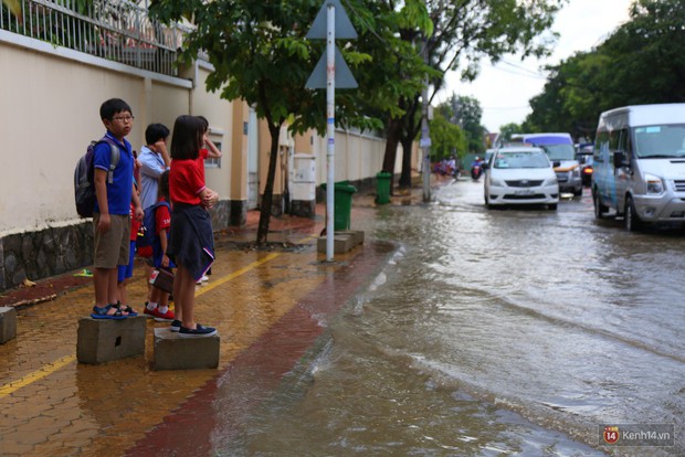 Phố nhà giàu Sài Gòn ngập nặng sau mưa, trẻ em tan học được cõng, bồng để lên xe về nhà - Ảnh 13.