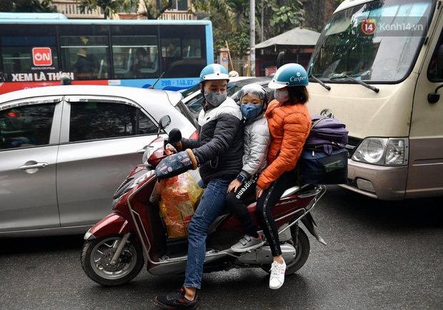 Chùm ảnh: Trẻ nhỏ trùm chăn, khoác áo mưa chật vật theo chân bố mẹ rời Thủ đô về quê ăn Tết - Ảnh 4.