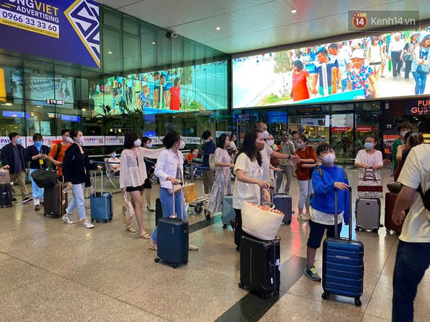 Chùm ảnh: Sân bay Tân Sơn Nhất tấp nập sau kỳ nghỉ Tết Dương lịch, nhiều người xách hành lý lỉnh kỉnh xếp hàng dài - Ảnh 2.