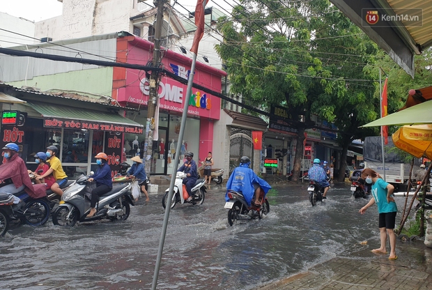 Đường Sài Gòn lại thành sông sau mưa, nước chảy cuồn cuộn như thác đổ - Ảnh 12.