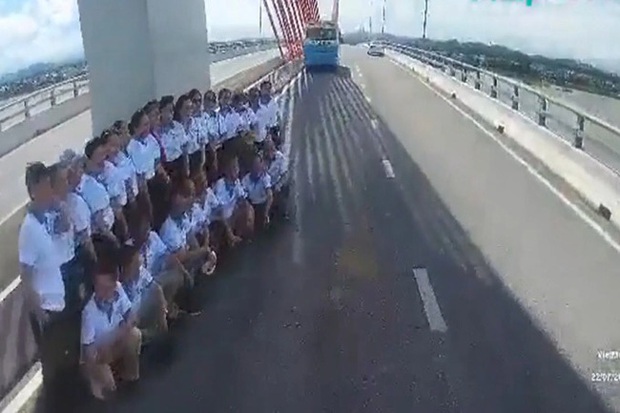 Nhóm người dàn hàng chụp ảnh trên cầu suýt bị ô tô tông trúng - Ảnh 1.