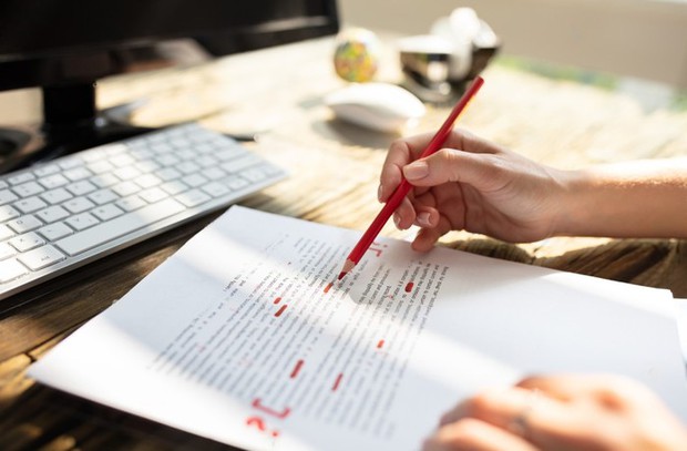 stock-photo-close-up-of-a-person-s-hand-marking-error-with-red-marker-on-document-1462384586-transformed-16740344930791113125634-1674165240441551122342.jpeg