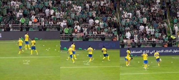 Ronaldo bị ném chai lọ khi ghi bàn từ chấm 11m - Ảnh 1.