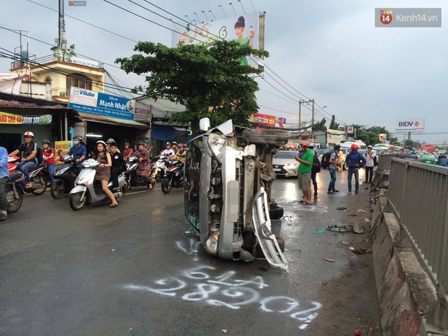 TP.HCM: Xe du lịch t&ocirc;ng bay 10m dải ph&acirc;n c&aacute;ch rồi lật ngang giữa đường - Ảnh 1.