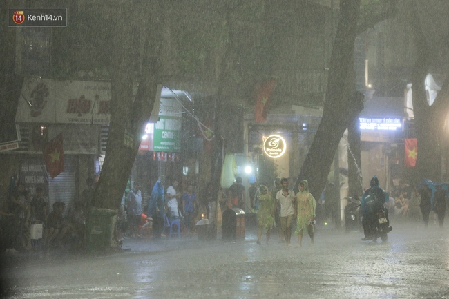 Chùm ảnh: Nhiều người thích thú tắm mưa đến ướt sũng trên phố đi bộ Hà Nội - Ảnh 5.