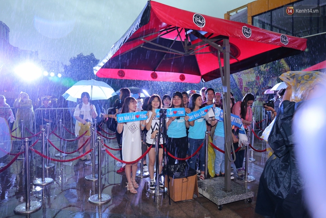 Fan đội mưa lớn chờ đợi, Sơn Tùng M-TP liên tục cười hạnh phúc và nhiệt tình ký tặng - Ảnh 1.