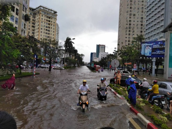 Nghệ An: Đường ngập như sông, công an xắn quần lội nước giúp dân vượt qua - Ảnh 1.