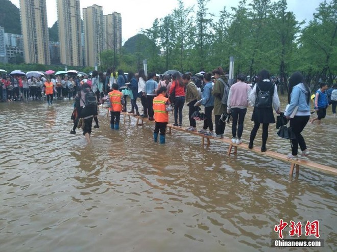 Sinh viên Trung Quốc gây tranh cãi vì để các nữ nhân viên vệ sinh lớn tuổi cõng qua chỗ lội - Ảnh 5.