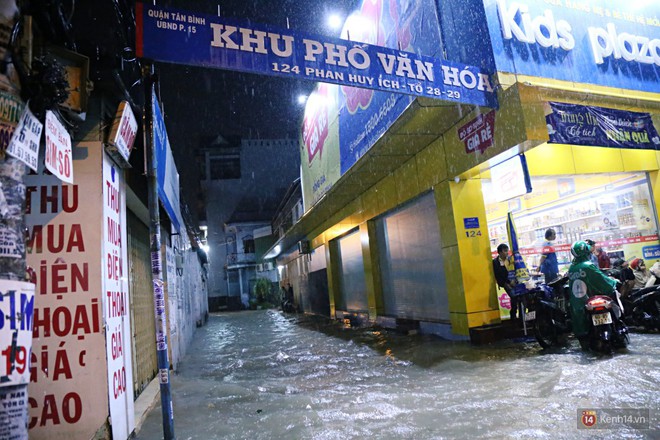 Học sinh, dân công sở khốn khổ vì nước ngập lút bánh xe trong cơn mưa kéo dài đến đêm ở Sài Gòn - Ảnh 4.