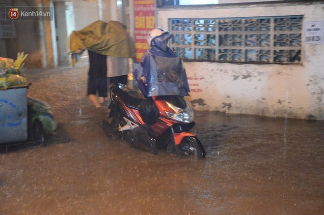 Mưa lớn kéo dài khiến đường phố Hà Nội hóa thành sông, nhiều người khốn đốn vì xe chết máy - Ảnh 11.