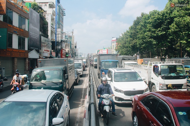 Chùm ảnh: Cửa ngõ sân bay Tân Sơn Nhất liên tục kẹt xe bất thường, ô tô dàn 2 hàng ép xe máy trên cầu vượt - Ảnh 1.