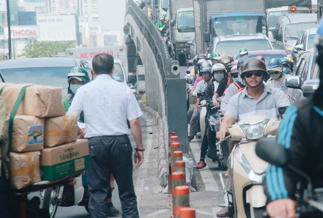 Chùm ảnh: Cửa ngõ sân bay Tân Sơn Nhất liên tục kẹt xe bất thường, ô tô dàn 2 hàng ép xe máy trên cầu vượt - Ảnh 3.