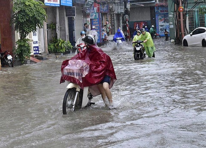 Người dân ngã sóng soài giữa dòng nước ngập trên đường phố Hà Nội sau cơn mưa - Ảnh 21.