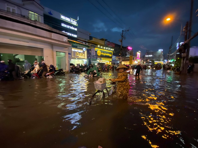 Nhiều tuyến đường Sài Gòn ngập lút bánh xe sau mưa lớn, nước chảy cuồn cuộn như lũ - Ảnh 11.