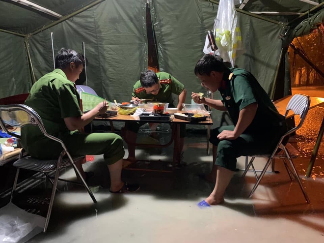 Xót xa hình ảnh chiến sĩ công an dầm mưa tại chốt phòng dịch Covid-19: Những bữa cơm ăn vội, mưa xối trên đầu và nước ngập dưới chân - Ảnh 2. Xót xa hình ảnh chiến sĩ công an dầm mưa tại chốt phòng dịch Covid-19: Những bữa cơm ăn vội, mưa xối trên đầu và nước ngập dưới chân - Ảnh 2.