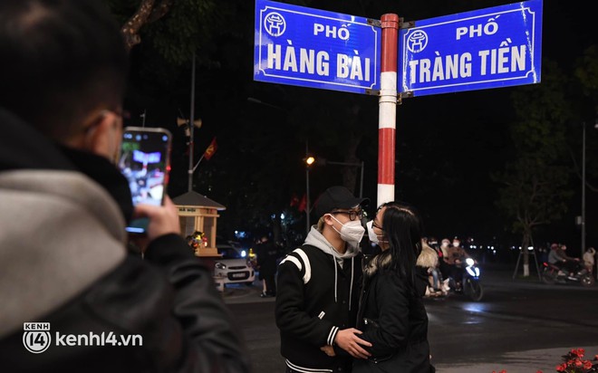 Ảnh: Nhiều cặp đ&ocirc;i trao nhau nụ h&ocirc;n qua lớp khẩu trang, đ&aacute;nh dấu thời khắc chuyển giao năm mới 2022 - Ảnh 4.