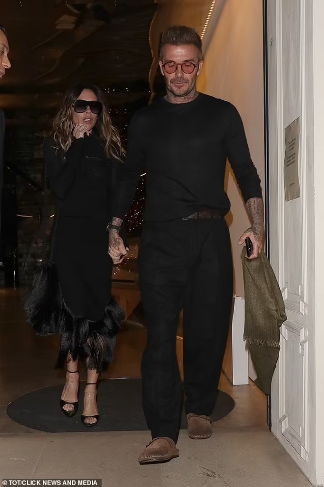 Vợ chồng David Beckham diện đồ đen, nắm chặt tay nhau khi ra phố - Ảnh 1.