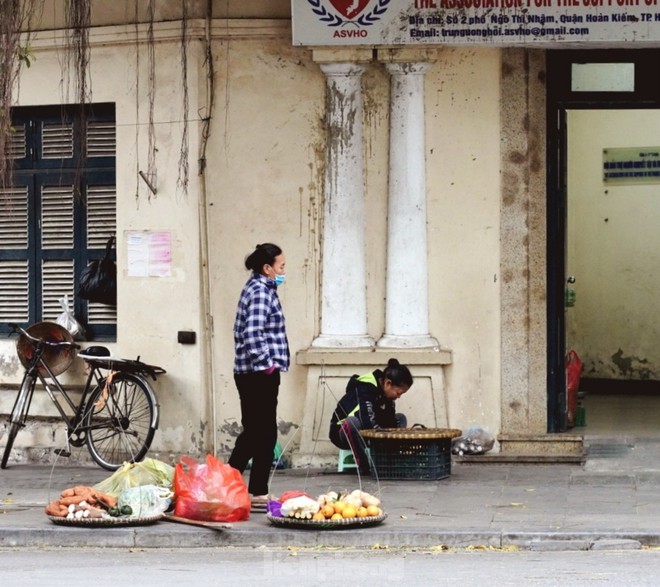 Người lao động ngoài đường phố Hà Nội quay quắt mưu sinh dưới mưa rét - Ảnh 2.