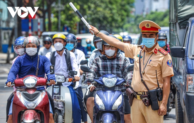 Cảnh sát giao thông Hà Nội đẫm mồ hôi làm nhiệm vụ giữa nắng đổ lửa - Ảnh 2.