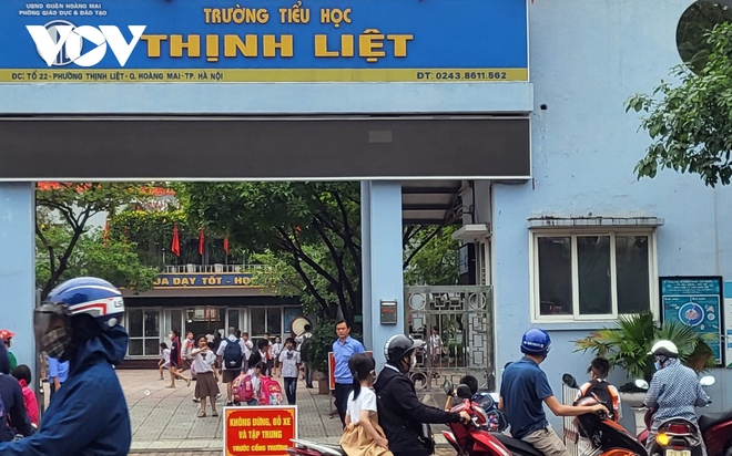 Nhiều phụ huynh H&agrave; Nội kh&ocirc;ng đội mũ bảo hiểm, lượn l&aacute;ch trong giờ tan tầm đi đ&oacute;n con - Ảnh 6.