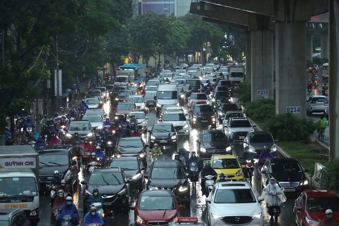 H&agrave; Nội: Mưa lớn đ&uacute;ng giờ đi l&agrave;m, người d&acirc;n chen ch&acirc;n giữa d&ograve;ng xe chật cứng - Ảnh 1.