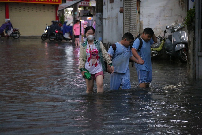 Người dân TP.HCM không kịp trở tay trong trận mưa lớn nhất kể từ đầu năm: Nước ngập gần lút bánh xe, tràn vào nhà - Ảnh 13.
