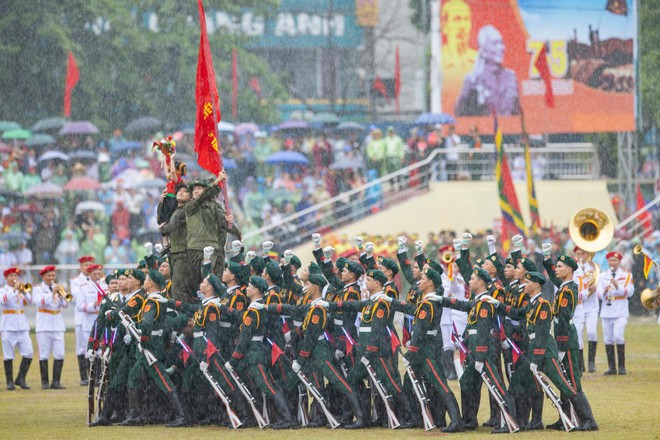Em bé tượng đài dưới mưa - khoảnh khắc ánh lên triệu niềm tự hào trong lễ kỷ niệm 70 năm chiến thắng Điện Biên Phủ - Ảnh 1.