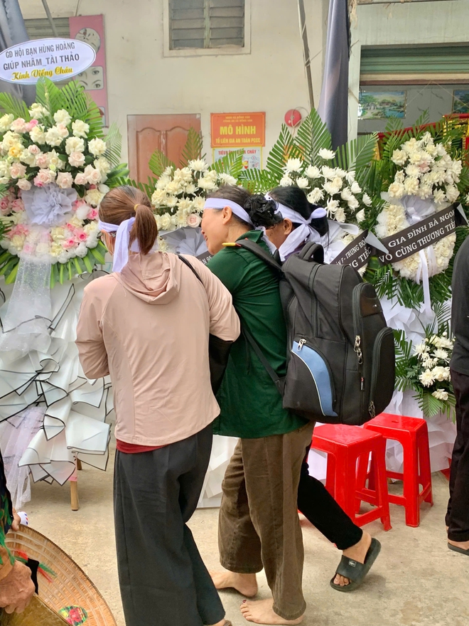 Mẹ Thượng &uacute;y L&ecirc; Văn Thắng kho&aacute;c qu&acirc;n phục, đeo ba l&ocirc; con trai trong lễ đưa tang ở Nghệ An - Ảnh 4.